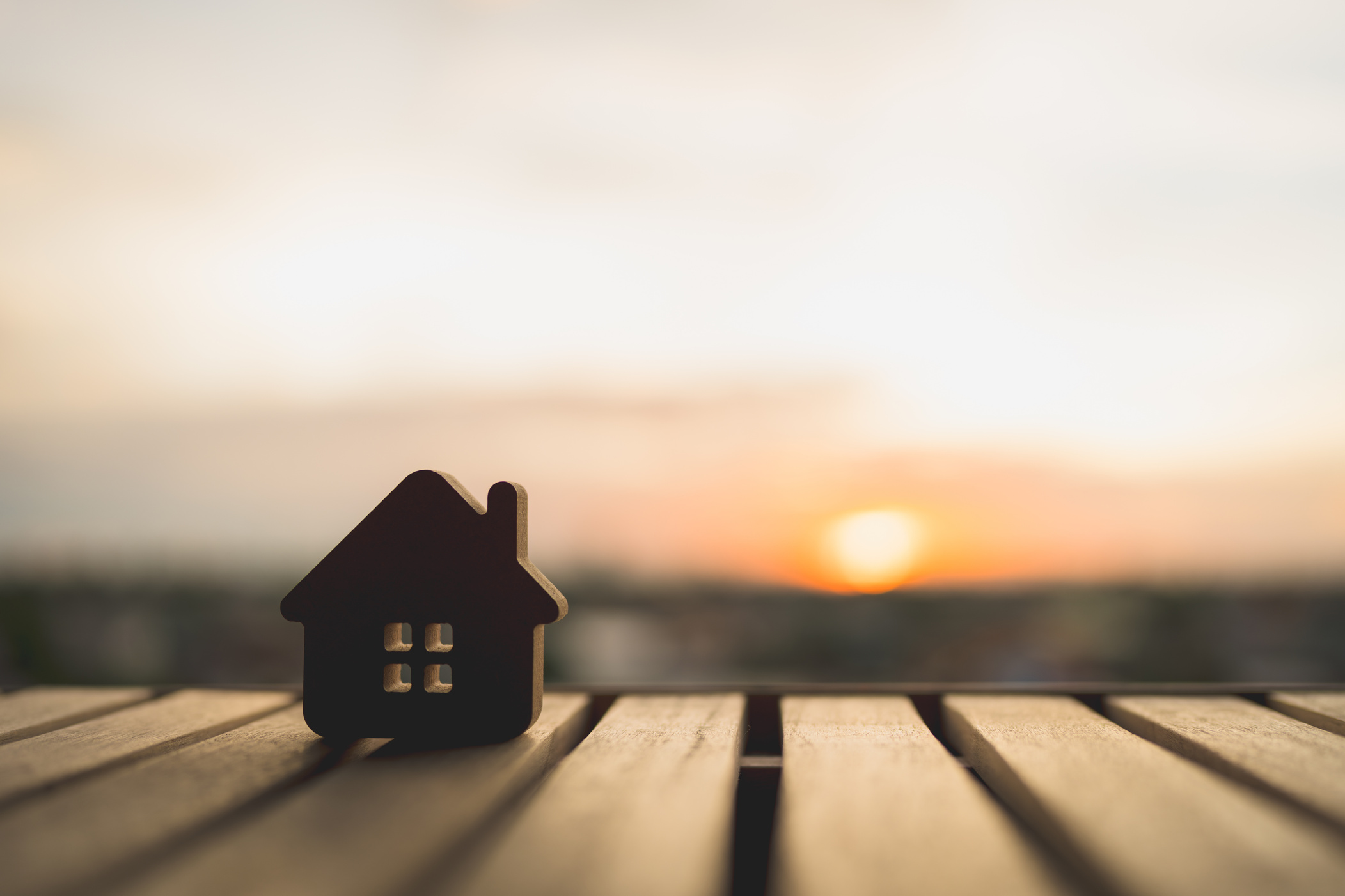 Wooden house model on wood background, a symbol for construction , ecology, loan, mortgage, property or home.